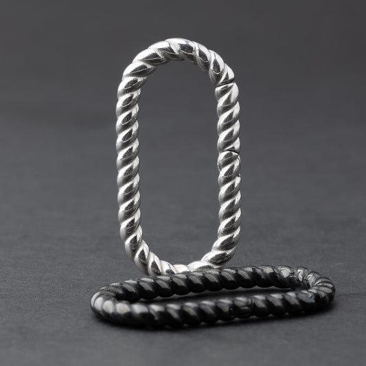 Twisted ear hangers in silver and black finishes displayed on a dark background, showcasing their rope-like design and bold style.