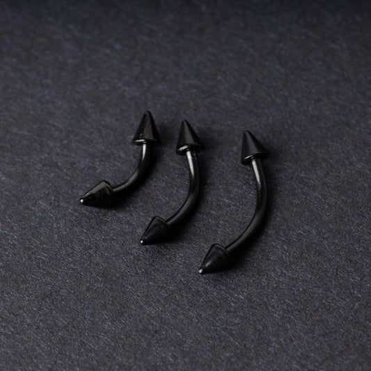 Three black curved barbells with spiked ends, displayed on a dark background with a polished finish.